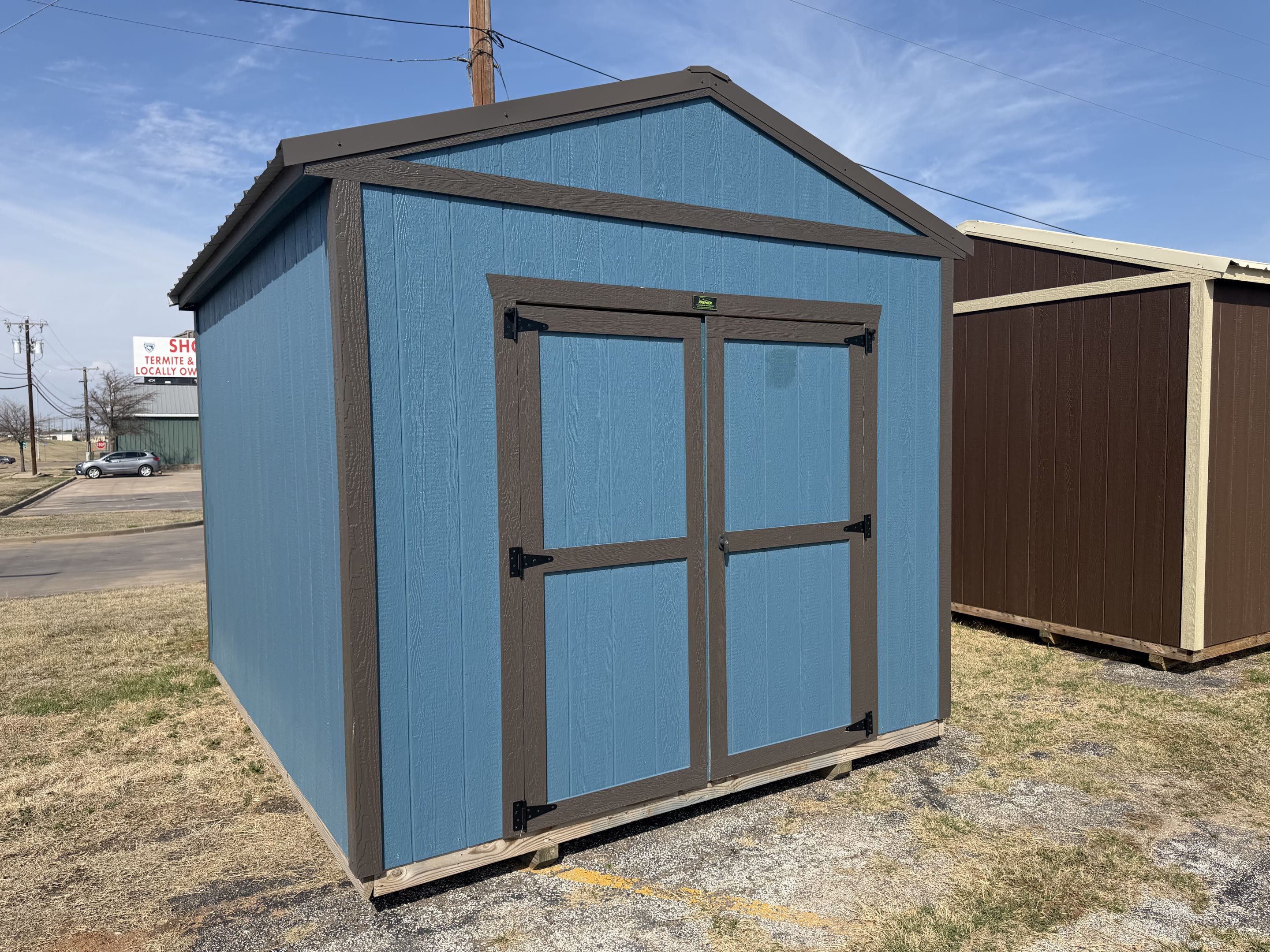 10x12 utility shed, blue LP SmartSide with dark brown trim and double doors